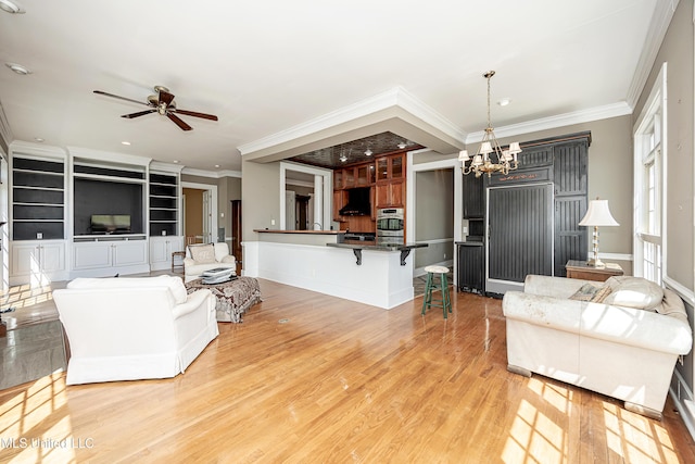 1401 Ladnier Rd, Gautier, MS 39553 - living room featuring crown molding, recessed lighting, ceiling fan with notable chandelier, and light wood finished floors