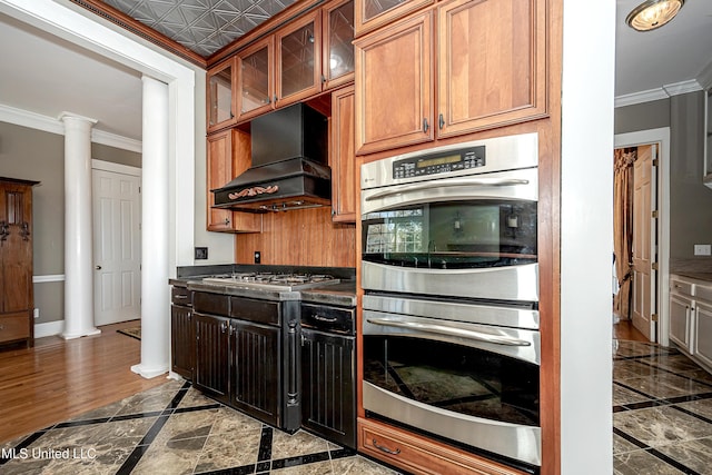 1401 Ladnier Rd, Gautier, MS 39553 - kitchen with ornate columns, ornamental molding, baseboards, appliances with stainless steel finishes, and custom exhaust hood