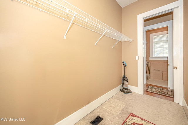 1401 Ladnier Rd, Gautier, MS 39553 - laundry room featuring carpet, baseboards, and visible vents