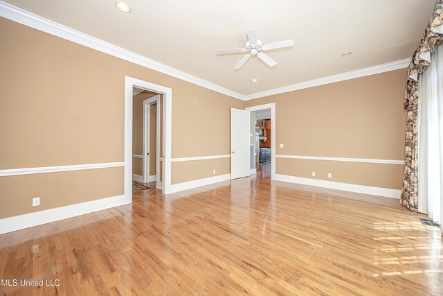 1401 Ladnier Rd, Gautier, MS 39553 - spare room featuring crown molding, a ceiling fan, baseboards, visible vents, and light wood-style floors