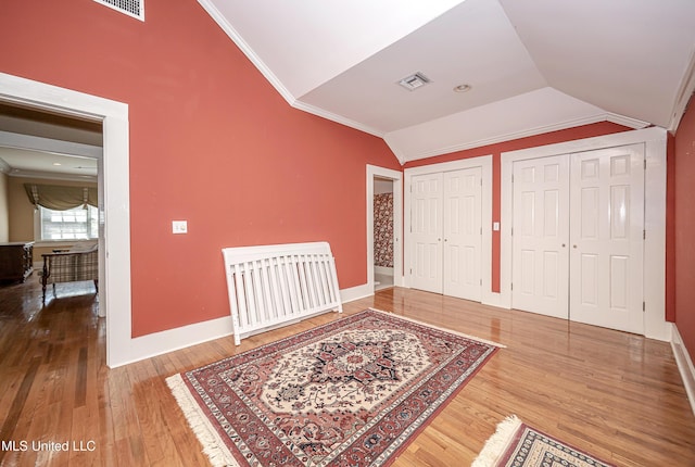 1401 Ladnier Rd, Gautier, MS 39553 - foyer entrance with visible vents, crown molding, baseboards, wood finished floors, and vaulted ceiling