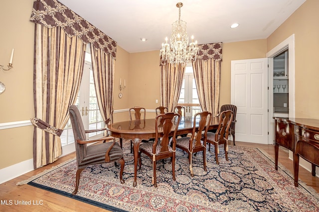 1401 Ladnier Rd, Gautier, MS 39553 - dining room with baseboards, wood finished floors, a notable chandelier, and plenty of natural light