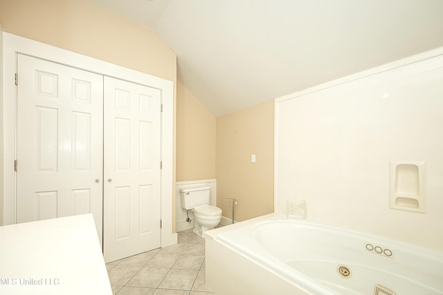 1401 Ladnier Rd, Gautier, MS 39553 - full bath featuring vaulted ceiling, toilet, tile patterned flooring, and a garden tub