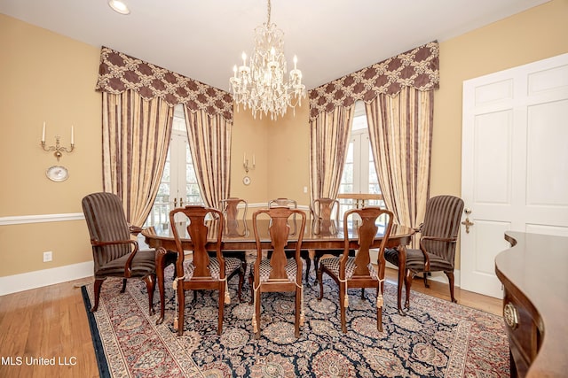 1401 Ladnier Rd, Gautier, MS 39553 - dining space featuring baseboards, wood finished floors, french doors, and plenty of natural light