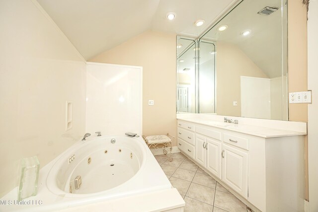 1401 Ladnier Rd, Gautier, MS 39553 - bathroom featuring a jetted tub, vaulted ceiling, tile patterned floors, and vanity
