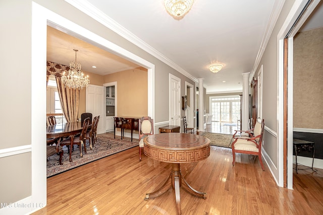 1401 Ladnier Rd, Gautier, MS 39553 - interior space featuring baseboards, ornamental molding, wood finished floors, and an inviting chandelier