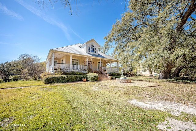 1401 Ladnier Rd, Gautier, MS 39553 - country-style home featuring covered porch, a front lawn, and metal roof