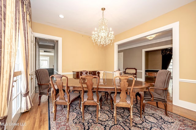 1401 Ladnier Rd, Gautier, MS 39553 - dining area with crown molding, a chandelier, and wood finished floors