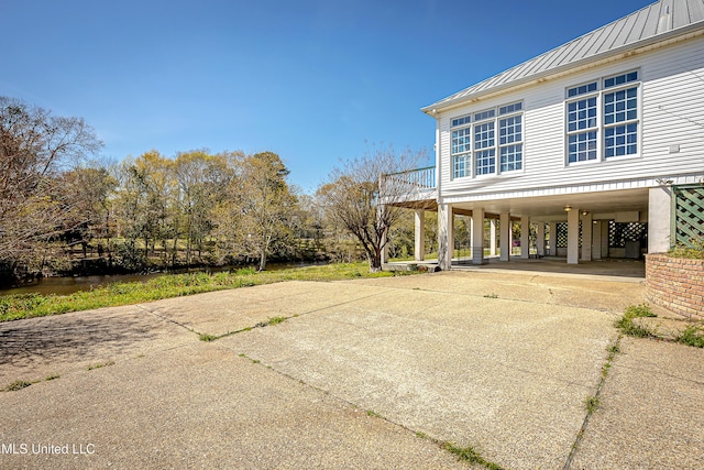 1401 Ladnier Rd, Gautier, MS 39553 - view of patio / terrace featuring driveway, a carport, and stairway