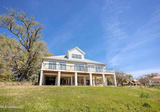 1401 Ladnier Rd, Gautier, MS 39553 - rear view of property with a lawn, metal roof, and a wooden deck
