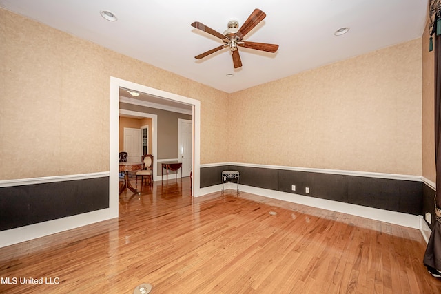 1401 Ladnier Rd, Gautier, MS 39553 - unfurnished room with wallpapered walls, ceiling fan, and wood finished floors