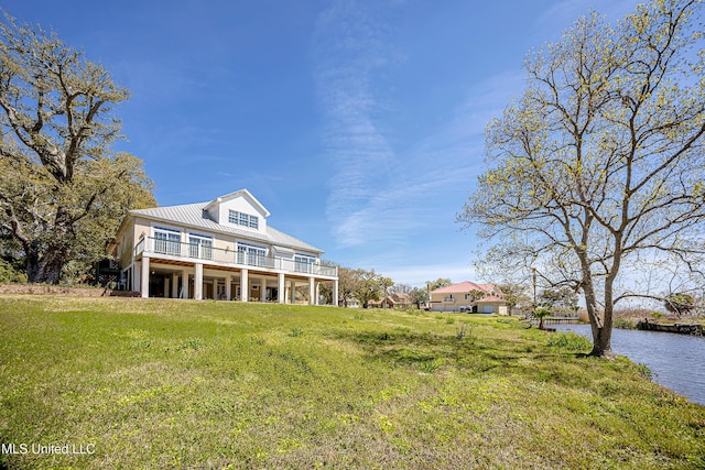 1401 Ladnier Rd, Gautier, MS 39553 - view of front of property featuring metal roof, a deck with water view, and a front yard