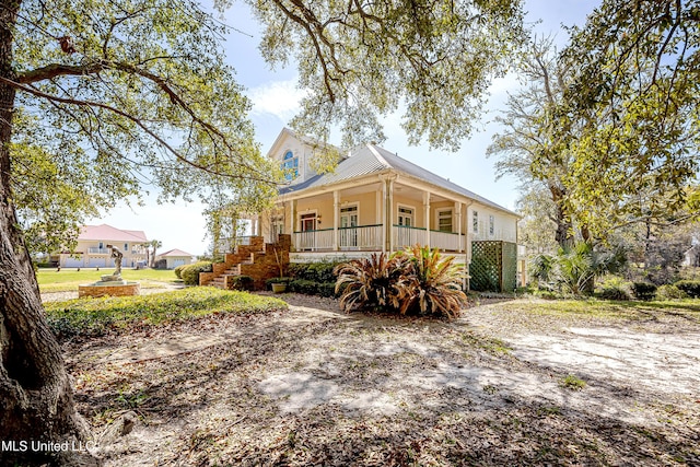 1401 Ladnier Rd, Gautier, MS 39553 - view of front of house featuring metal roof and covered porch