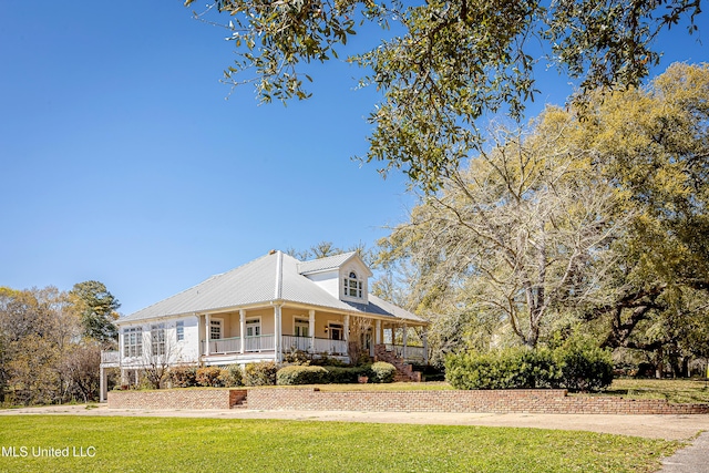 1401 Ladnier Rd, Gautier, MS 39553 - view of front of property featuring metal roof, a front yard, and covered porch