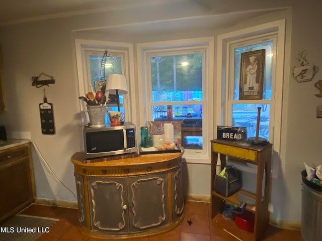 sitting room with tile patterned floors and ornamental molding