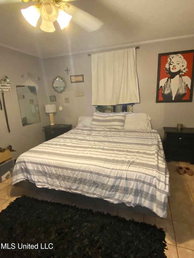 bedroom with tile patterned floors, ceiling fan, and crown molding