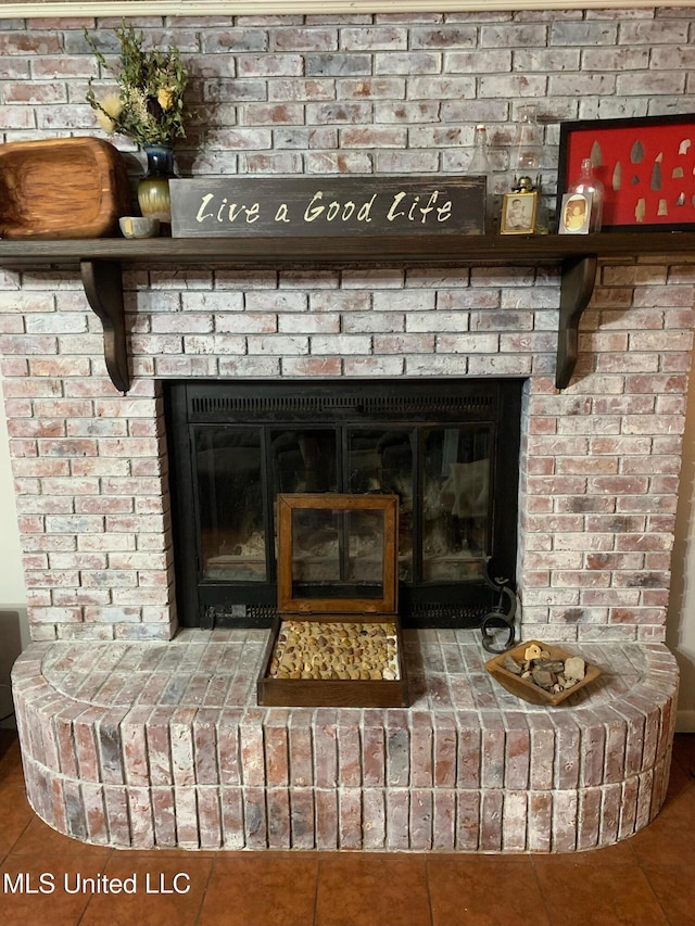 interior details with tile patterned flooring and a fireplace