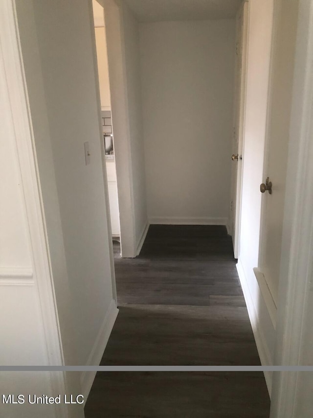 hallway with dark hardwood / wood-style flooring