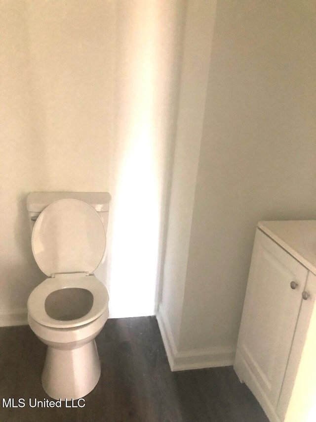 bathroom with wood-type flooring and toilet