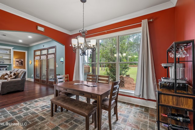 10 Magnolia Crossing Rd, Sumrall, MS 39482 - dining space featuring arched walkways, crown molding, a chandelier, baseboards, and brick floors