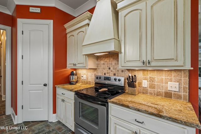 10 Magnolia Crossing Rd, Sumrall, MS 39482 - kitchen featuring electric stove, custom exhaust hood, cream cabinets, tasteful backsplash, and ornamental molding
