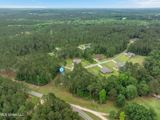 10 Magnolia Crossing Rd, Sumrall, MS 39482 - aerial view of property and surrounding area featuring a heavily wooded area