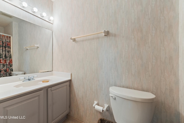 bathroom featuring vanity and toilet