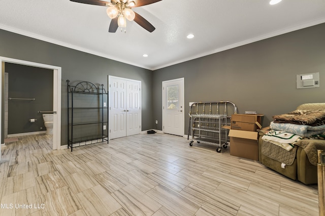 bedroom with a closet, ornamental molding, ensuite bathroom, and ceiling fan