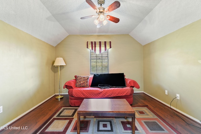 living room with a textured ceiling, vaulted ceiling, and dark hardwood / wood-style flooring