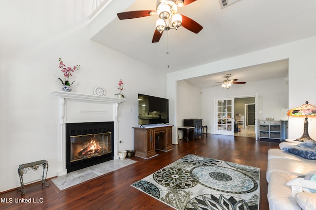 living room with wood-type flooring and ceiling fan