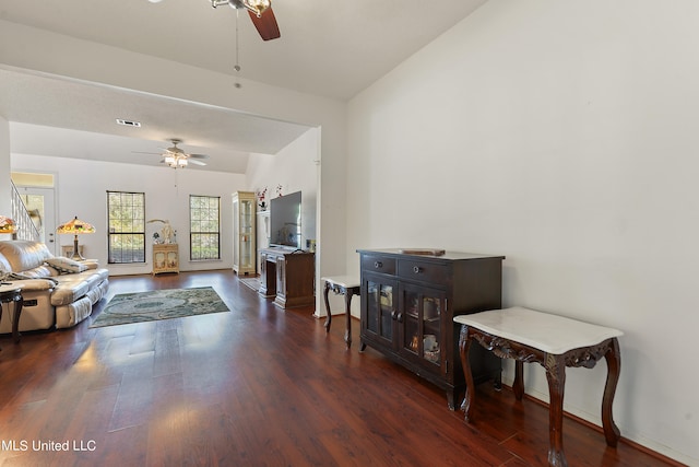 living room featuring ceiling fan, lofted ceiling, and dark hardwood / wood-style flooring