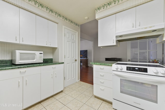 kitchen featuring white cabinetry, white appliances, and light tile patterned floors