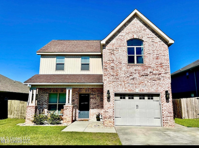 view of front of property featuring a front yard and a garage