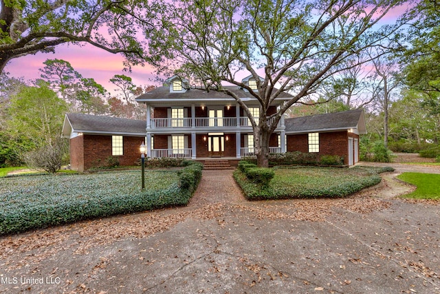 greek revival inspired property featuring covered porch