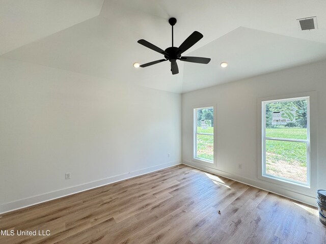 unfurnished room with vaulted ceiling, light hardwood / wood-style flooring, and ceiling fan