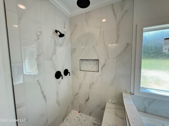 bathroom featuring crown molding and tiled shower