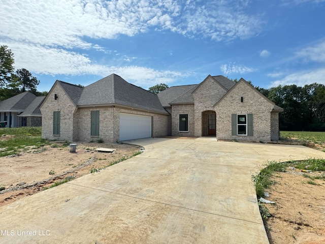 french country inspired facade featuring a garage