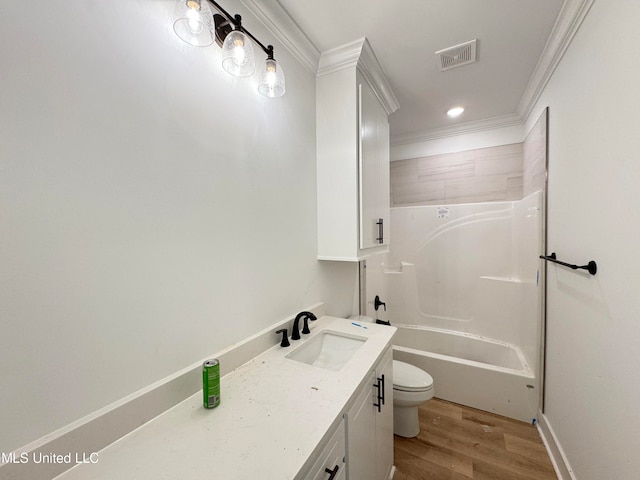 full bathroom with bathing tub / shower combination, crown molding, wood-type flooring, toilet, and vanity