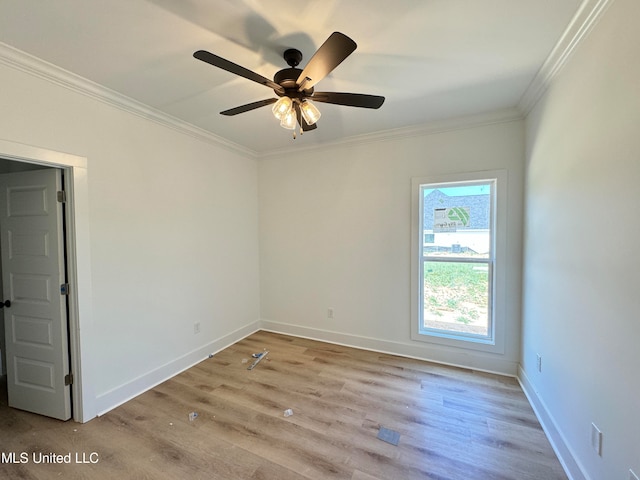 empty room with light wood-type flooring, ceiling fan, and ornamental molding