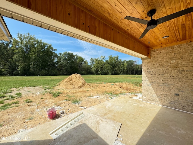 view of yard with ceiling fan and a patio area