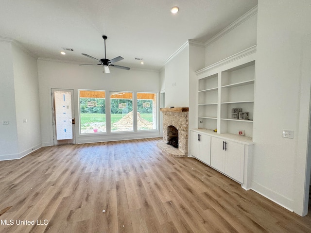 unfurnished living room featuring a fireplace, ceiling fan, light wood-type flooring, and crown molding