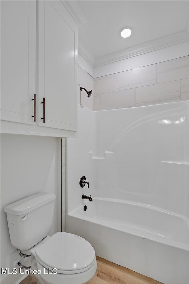 bathroom featuring washtub / shower combination, toilet, and wood-type flooring