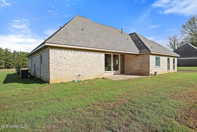 back of house featuring a lawn, cooling unit, and a patio