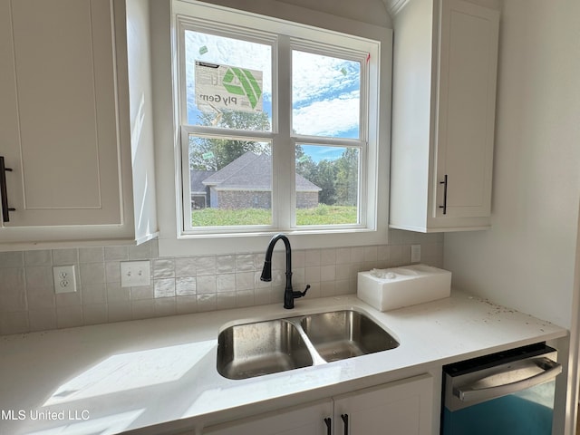 kitchen featuring dishwasher, white cabinets, and a healthy amount of sunlight