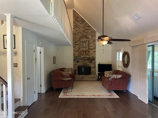 4858 Victoria Dr, Nesbit, MS 38651 - living room featuring a high ceiling, dark wood-style flooring, a ceiling fan, a fireplace, and stairs