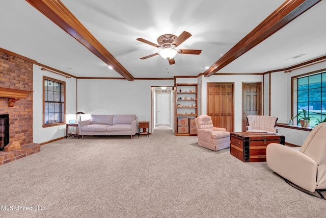8140 Hunters Hill Cv, Olive Branch, MS 38654 - carpeted living area featuring crown molding, beam ceiling, ceiling fan, a brick fireplace, and baseboards