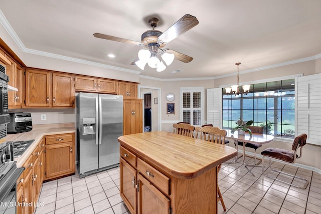 8140 Hunters Hill Cv, Olive Branch, MS 38654 - kitchen with stainless steel fridge, light tile patterned floors, light countertops, a ceiling fan, and a chandelier