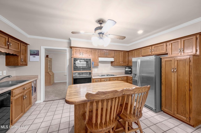 8140 Hunters Hill Cv, Olive Branch, MS 38654 - kitchen featuring black appliances, a sink, light tile patterned floors, under cabinet range hood, and crown molding