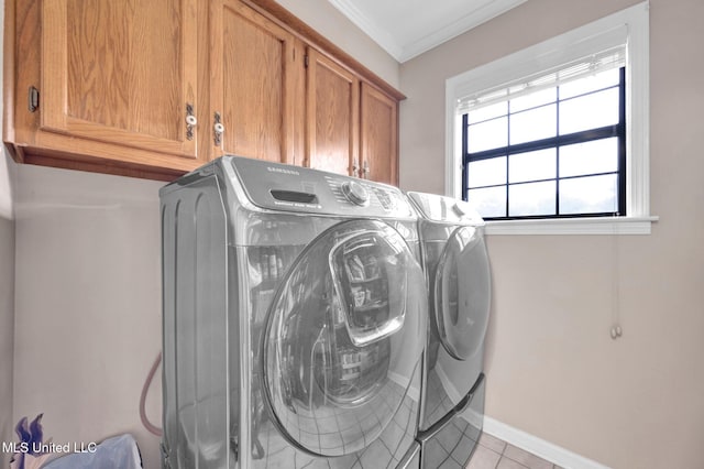 8140 Hunters Hill Cv, Olive Branch, MS 38654 - laundry area featuring cabinet space, independent washer and dryer, baseboards, ornamental molding, and light tile patterned floors