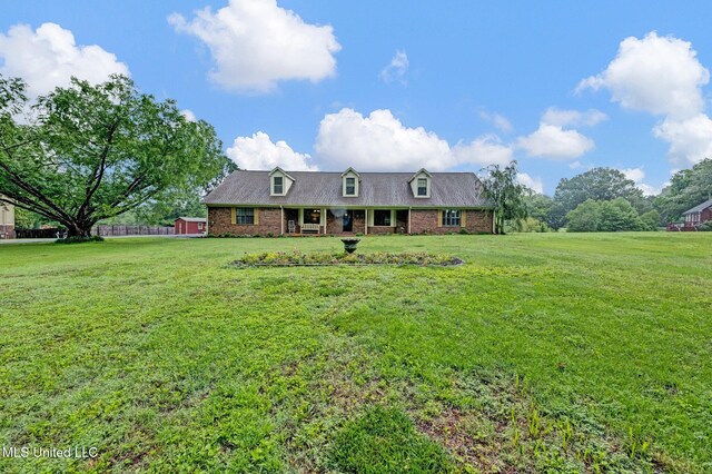8140 Hunters Hill Cv, Olive Branch, MS 38654 - cape cod-style house featuring a front lawn and brick siding